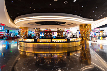 UAE, DUBAI, NOVEMBER, 2022: Modern futuristic interior in Duty Free zone at Dubai airport, UAE. Jewelry store with golden decoration and backlight.のeditorial素材