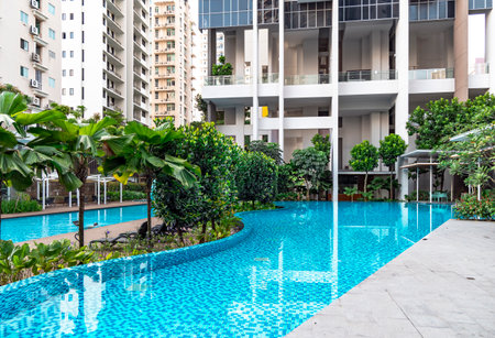 Southeast Asia, Singapore, November, 2022: Modern high-rise residential apartment with a beautiful tropical garden and swimming pool for general use in Singapore.のeditorial素材