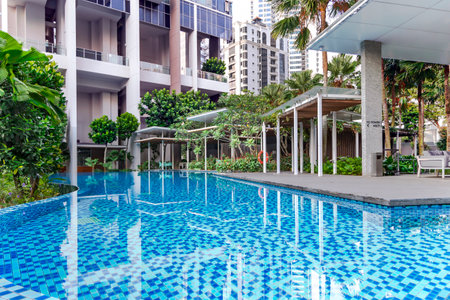 Southeast Asia, Singapore, November, 2022: Modern high-rise residential apartment with a beautiful tropical garden and swimming pool for general use in Singapore.のeditorial素材