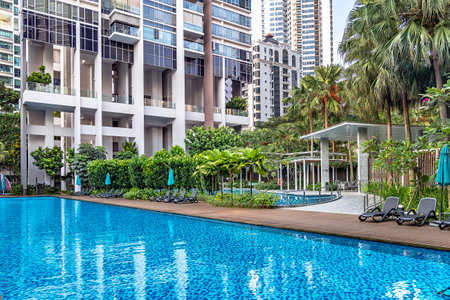 Southeast Asia, Singapore, November, 2022: Modern high-rise residential apartment with a beautiful tropical garden and swimming pool for general use in Singapore.のeditorial素材