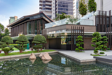 Southeast Asia, Singapore, November, 2022: Beautiful  oriental park with decorative trimmed boxwood trees and around small pond in Balestier district, Singapore.のeditorial素材