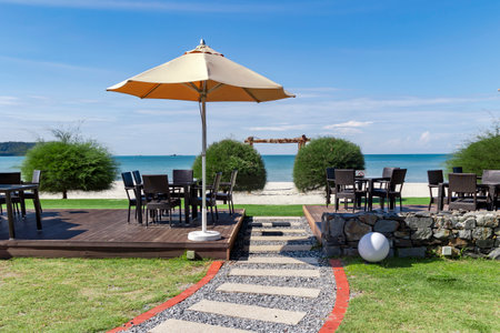 Outdoor cafe veranda with wicker furniture on Cenang beach on the Andaman Sea coast in Langkawi island, Malaysiaの写真素材