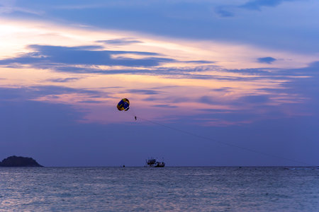Parasailing on the sea at sunset.の写真素材