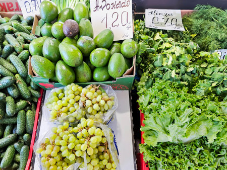 Fresh organic vegetables and fruits from farmer market. Vegetarian salads, cucumbers, avocado and light grapesの写真素材