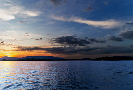 Majestic dramatic sunset sky in evening time over the Andaman sea in Phuket island, Thailand. Tranquil relaxing sunlight summer vibes.の写真素材
