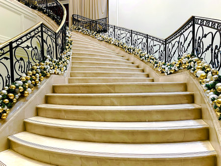 Marble staircase with beautiful black wrought iron railings and Christmas decorations  frontal viewの写真素材