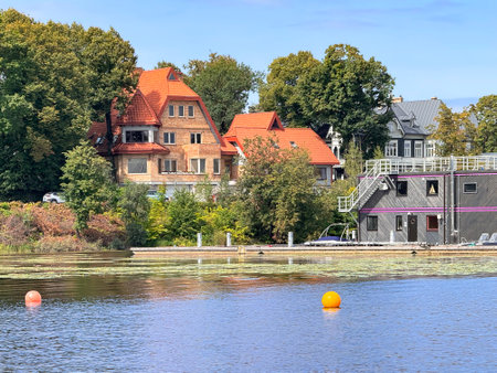 Private cottages with a boat dock on the bank of the Daugava river in Kipsala, Riga. Latviaの写真素材