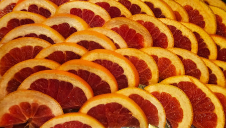 A plate with sliced ââfresh juicy red grapefruit wedges close-up. Vitamins and minerals for healthy eating.の写真素材