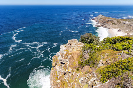 The rocky shore of Cape Agulhas, where the Indian and Atlantic Oceans meet, is a cape in South Africa, the southernmost point of Africa.の写真素材