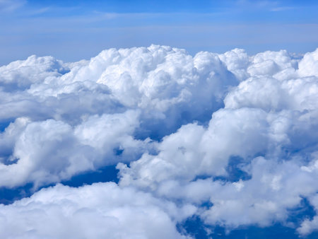 White fluffy clouds in the upper atmosphere against a clear blue sky. Sky, peace concept. Quiet and calm atmosphere.の写真素材