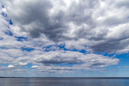 Panorama of the warm Gulf of Riga of the Baltic Sea against the background of cumulus clouds. The coast of the Gulf of Riga in Latvia is popular with tourists.の写真素材