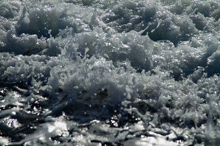 Foam of the sea surf on the beach of the Black Sea.の写真素材