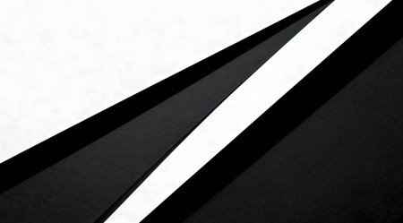 This image features a modern and minimalist design with a series of intersecting lines creating a dynamic abstract pattern. The stark contrast between the black and white colors emphasizes the geometric shapes and clean lines, suitable for use in contemporary art projects or as a sophisticated backdrop in digital media. The composition conveys a sense of order and simplicity. AI-generated illustration.の素材