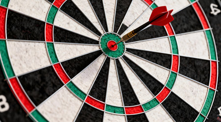 This image showcases a high-contrast dartboard with a vivid red and green target center, surrounded by alternating black and white rings. The bright lighting enhances the clarity and sharpness of the dartboard's surface, creating a professional and dynamic sports illustration. Ideal for sports-related graphics, game design, or as a striking visual element in editorial content. AI-generated illustration.の素材