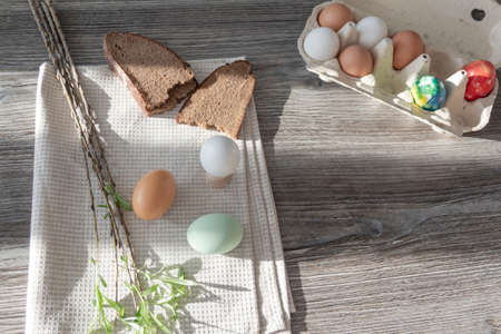 Chicken eggs painted in bright colors are on a wooden tableの写真素材