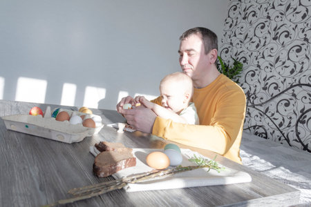 A dad celebrates Easter with his young son. They beat eggs, eat eggs and have breakfast. Dad teaches...