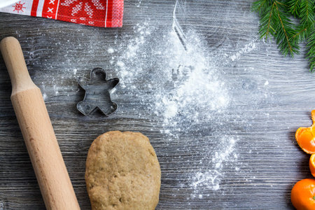 New Year and Christmas decorations on a wooden surface sprinkled with flour with tangerines and a...