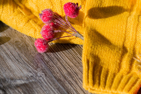 New Year and Christmas decorations and decorations with a yellow sweater on a wooden surface...