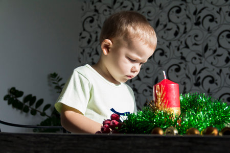 A little boy is looking forward to Christmas and New Year. waiting for a miracleの写真素材