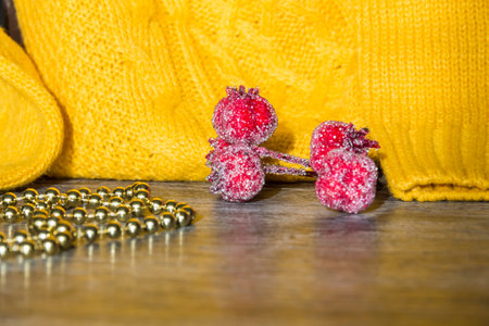 New Year and Christmas decorations and decorations with a yellow sweater on a wooden surface background. Preparation for the holiday.の写真素材