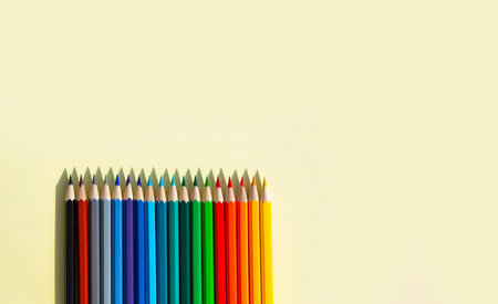 A large number of sharpened colored pencils with falling shadow from natural light on a bright sunny day.の写真素材