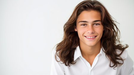 Happy cheerful young latino generation z. Smiling funny ethnic cool generation z teenage student, long hair, white background. Advertising teenage cosmetics, hair care products, medicines, perfumes, cosmetology, courses, college schools and trainingsの素材