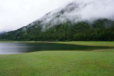 misty lake in the bavarian alpsの写真素材