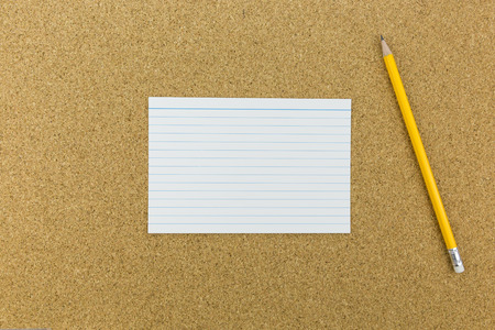 pencil with paper on cork boardの写真素材