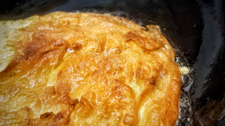 Thai style pork omelette on pan.