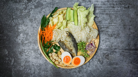 Spicy rice noodle salad withe herb on cement table.
