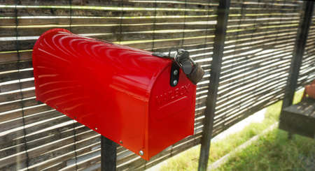 A Red metal meailbox locked.の写真素材