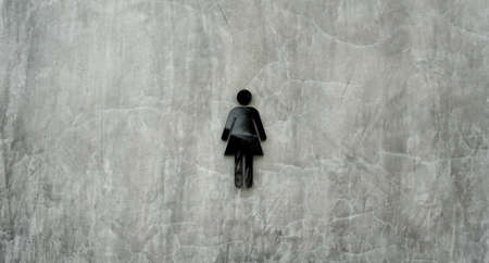 Women toilet sign on monochromic concrete background.の写真素材