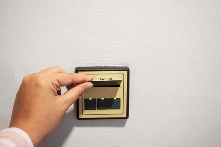 Hand inserting key card in electronic lock
