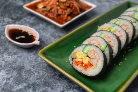 Korean food, Gimbap or Kimbap is seaweed rice roll and kimchi side dish.の写真素材