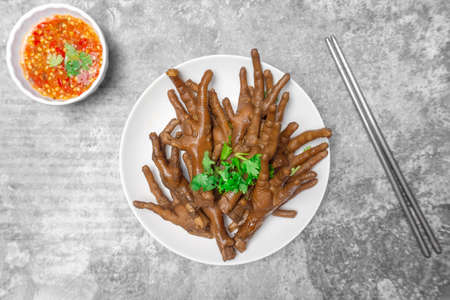 Top view Chicken feet stewed with herb and spicy dipping sauce, Asian street food.の写真素材