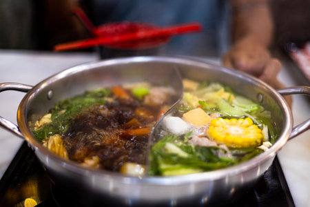 Chinese Hot Pot. Double flavor hot pot on the table.