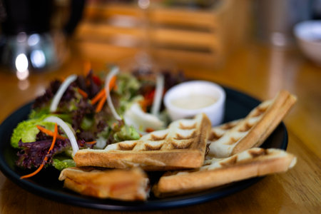 Served breakfast with waffles And Salad on light background. Delicious healthy food concept.の写真素材