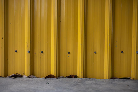 The background is plain and simple. Yellow corrugate wall background and textureの写真素材