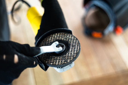 Hands and grinder. Close up of hands adjusting grinder for work.の写真素材