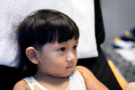 Close up shot of a boy sitting and staring.の写真素材