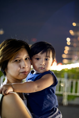 Portrait of mother with her son at outdoor market.の写真素材