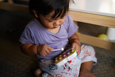 Little Boy Is Playing A Musical Instrument Colorful Wooden Toy Xylophone, Background for advertising and wallpaper in education and lifestyle scene.の写真素材