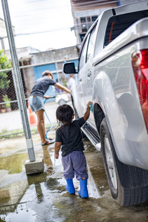 Mother And Little Boys Washing Carの写真素材