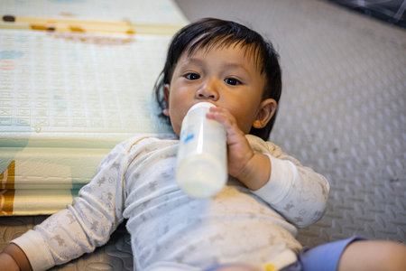 Toddler Drinking Milk In The Playroom, Background for advertising and wallpaper in kids and...
