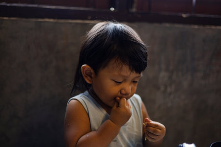 Toddler Is Eating Noodles With His Hands, Background for advertising and wallpaper in lifestyle and food scene.の写真素材