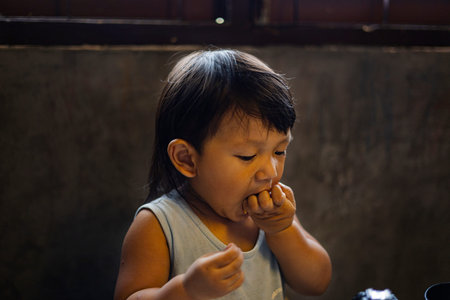 Toddler Is Eating Noodles With His Hands, Background for advertising and wallpaper in food and lifestyle scene.の写真素材