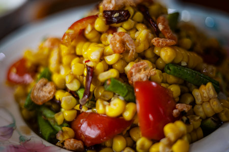 Thai Spicy Corn Salad With Salted Egg And Dried Shrimp, A vibrant Thai spicy corn salad with salted egg and dried shrimp bursts with color on table, perfect for a savory photo or a visual display.の写真素材