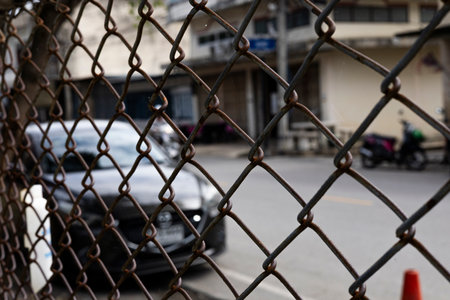 Close Up Of Steel Wire Mesh Gate, A detailed steel wire mesh gate shines with intricate patterns, reflecting sharp edges under daylight, perfect for industrial photo shot or modern security showcase.の写真素材