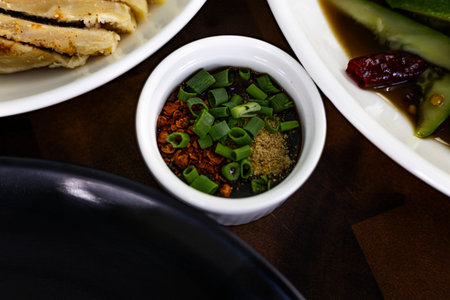 Spicy Jaew Bowl On Cozy Dining Glow, A fiery spicy jaew bowl rests in a soft dining glow, aromas wafting with zest, ideal for a culinary photo capture or a comforting dish display.の写真素材