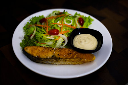 Salmon Salad On A Wooden Table, A colorful salmon salad sits on a wooden table, zesty flavors shining through, ideal for an ad campaign food photo or a nutritious dish promotion display.の写真素材